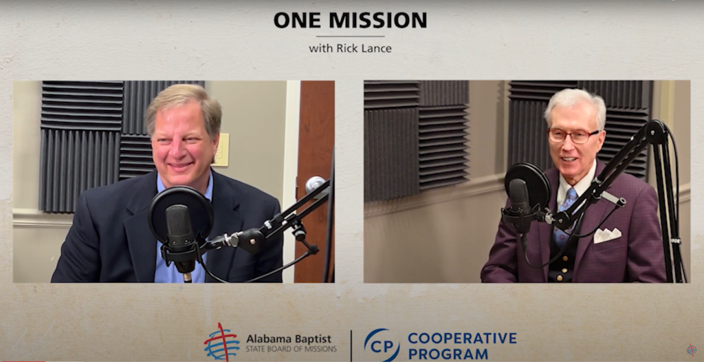 Buddy Champion and Rick Lance sit in front of microphones recording a podcast